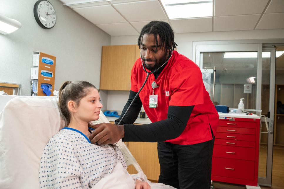 Nursing student Joseph White '24 practices skills in the simulation lab on the Carthage College c...