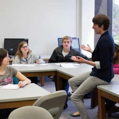 Prof. Haley Yaple helps students in a math class.