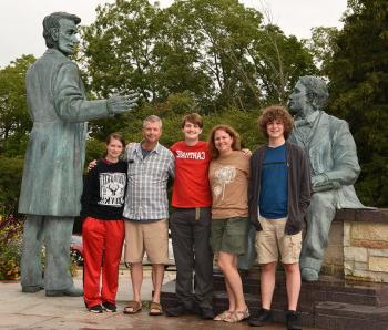 Family members pose with a new Carthage student in front of the Lincoln statue.